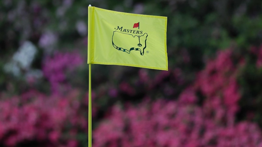 A close-up shot of the top of a flag on the green at Augusta National during the Masters.