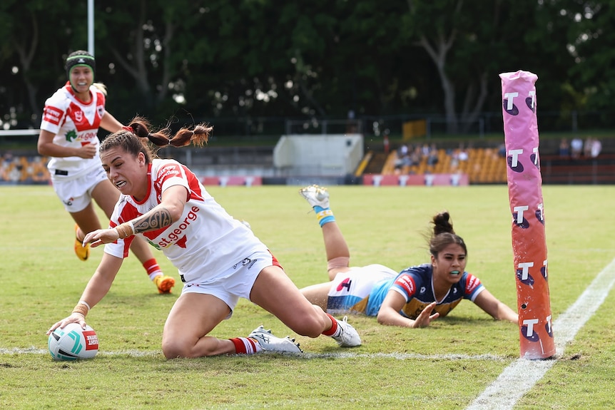 A woman scores a try in an NRLW match