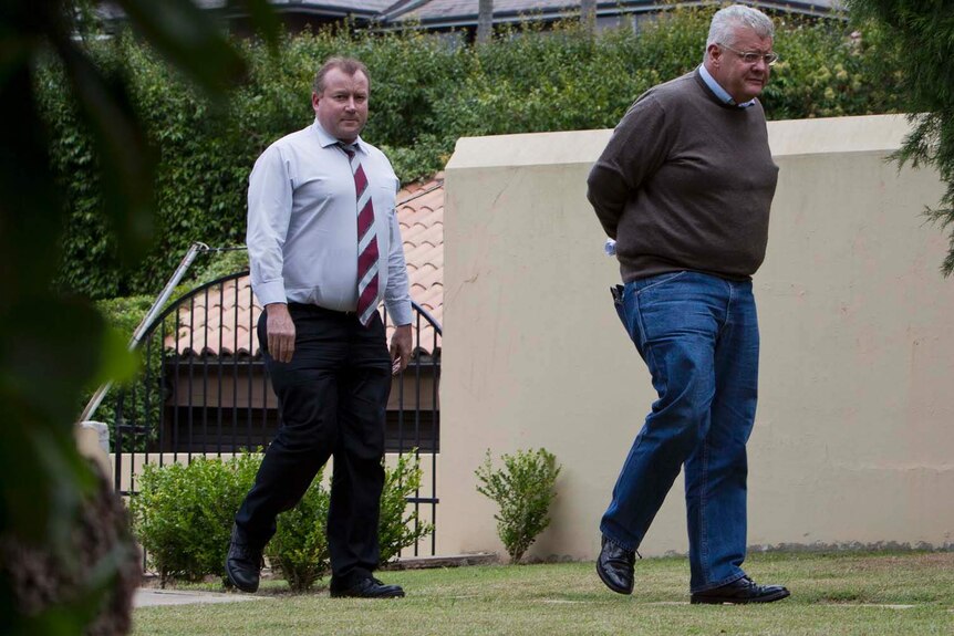 Jim Byrnes (right) arrives home with detectives