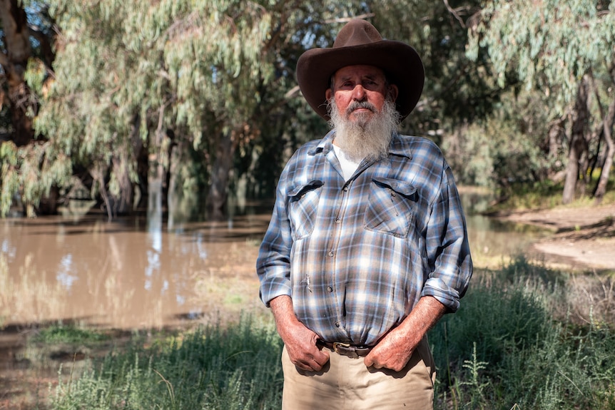Former shearer John McMaster stands on the banks of the Darling River at Louth, Western New South Wales, April 2021.