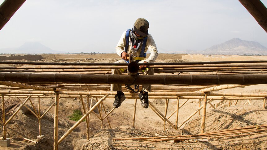 A worker constructs a structure to protect the mud and sand walls of the UNESCO listed ancient site of Chan Chan