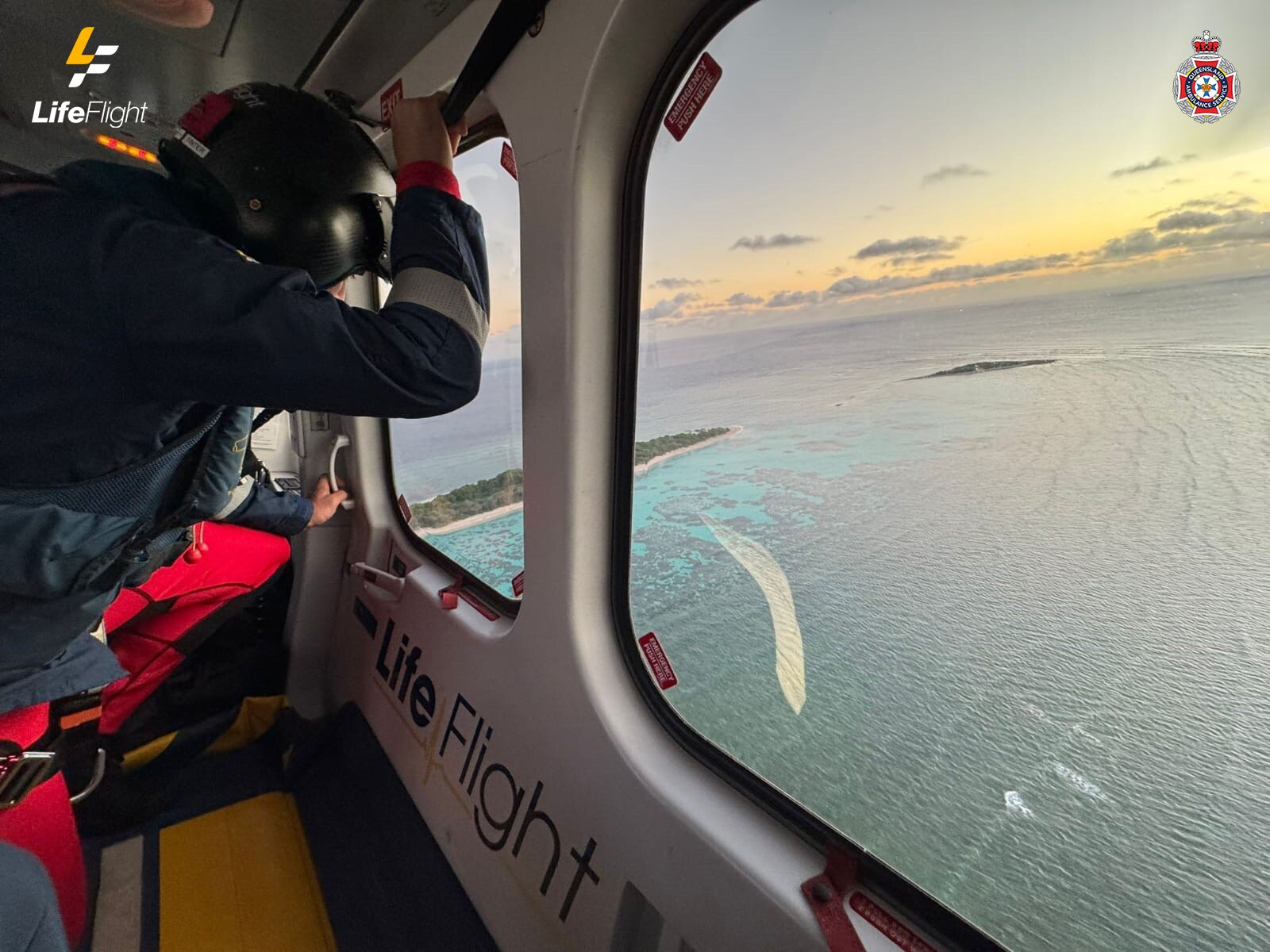 A person looking out into the ocean from a helicopter
