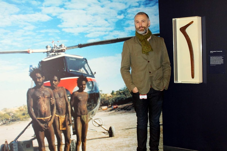 NMA consultant curator Dr John Carty with the wirlki boomerang and a photo by John Veevers.