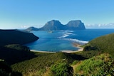 Lord Howe Island with beach in the foreground and rocky outcrops in the background