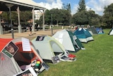 A row of tents at a rally, highlighting homelessness