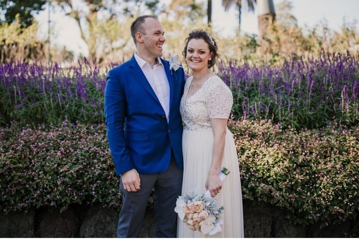 A photo of a man and woman smiling on their wedding day