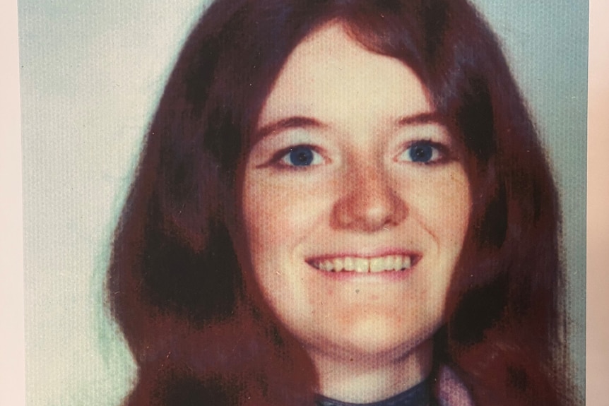 A photograph of Rita Curran smiling with red hair