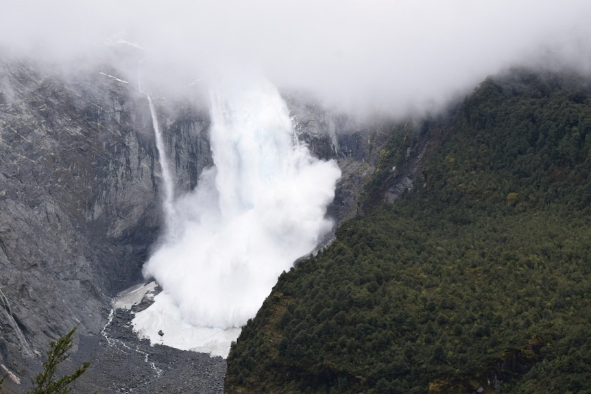 A glacier is pictured calving into the river