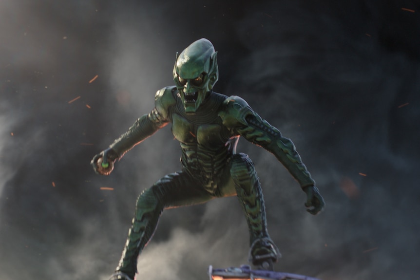Green Goblin, a man in a muscular green body suit with an alien-looking mask, squats, with a threatening expression