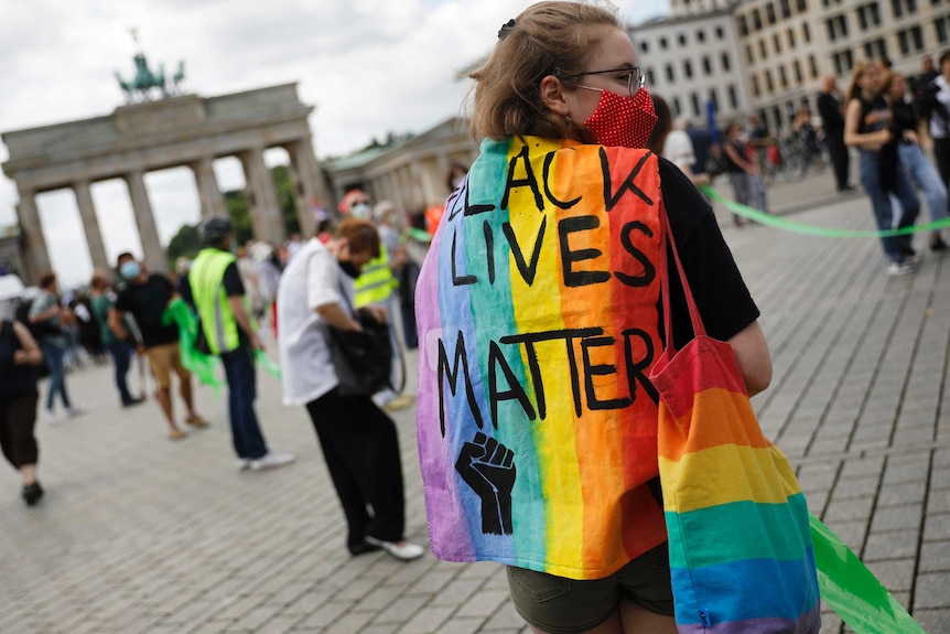 A woman in Berlin joins thousands creating a 9 kilometre human-chain.