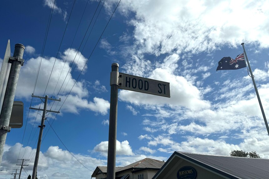 A sign that reads "Hood St" in a suburban area.