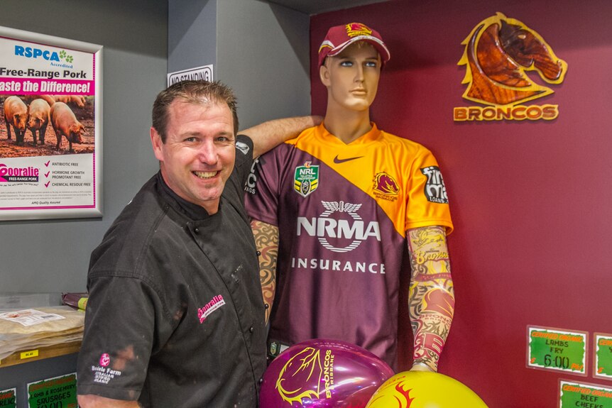 Owner Matt Roberts with 'Darren Lockyer' who watches over the store during the football season.