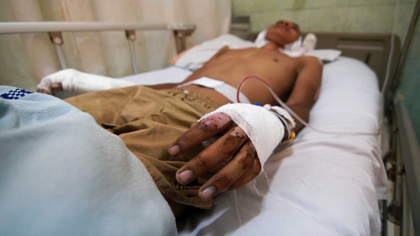 Close up of hand of a young man lying on a hospital bed