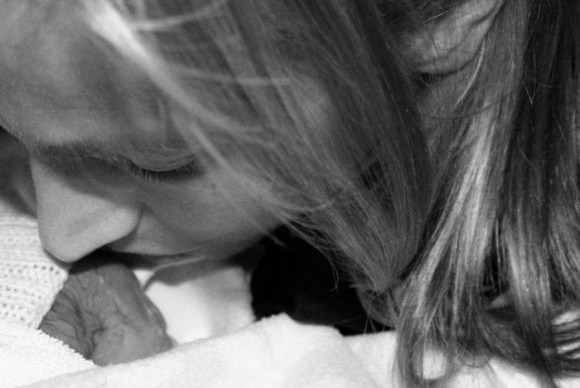 Alison Homer kissing her stillborn daughter, Harper, on the cheek.