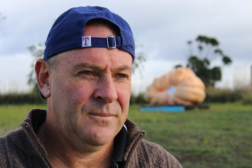 Man and pumpkin.