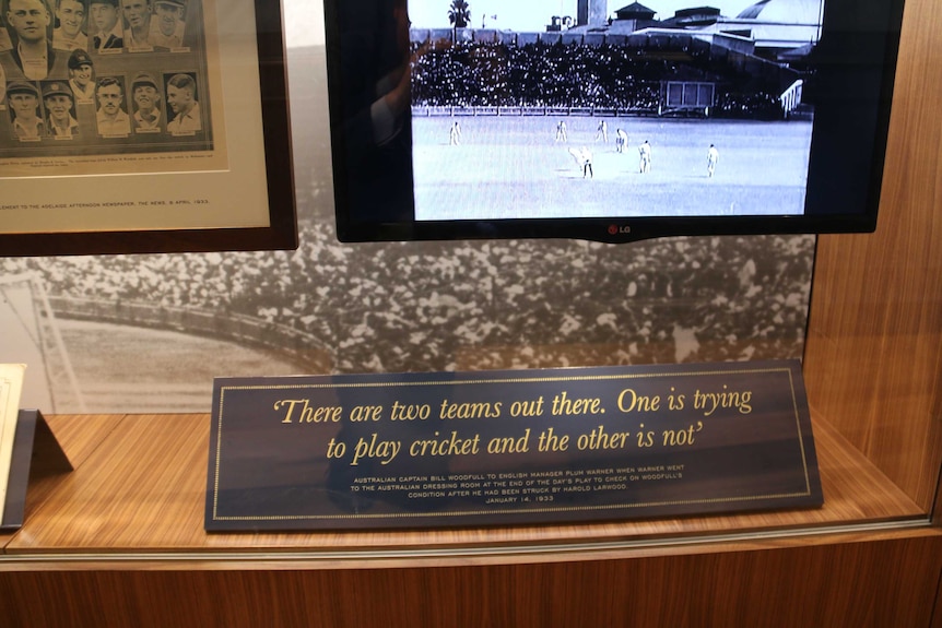 A placard featuring a Bill Woodfull quote: "There are two teams out there. One is trying to play cricket and the other is not."