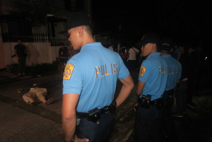 Filipiono police secure a crime scene after a former policeman and drug runner was killed, July 2016