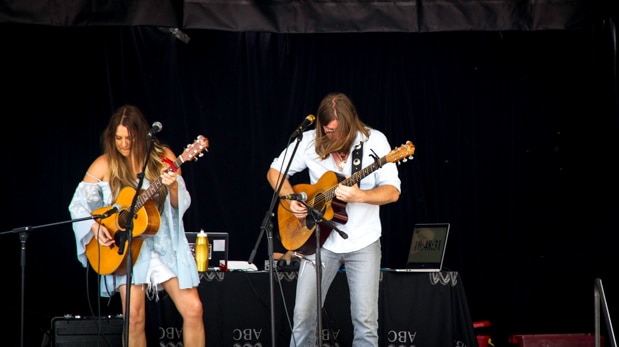 Adam Eckersley and Brooke McClymont performing on stage.