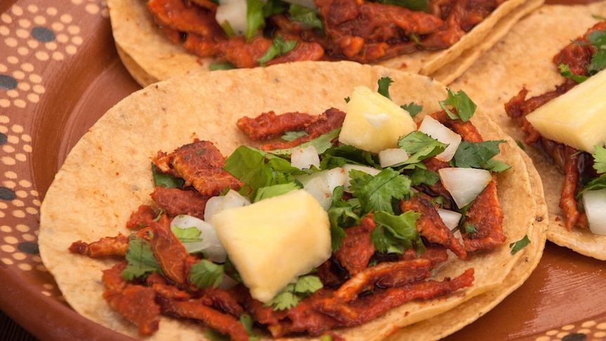 taco with pork and pineapple toppings