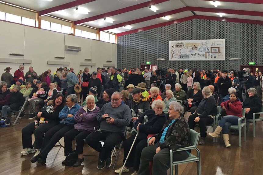 Community members gather in Charlton, in western Victoria, as floodwaters rise.