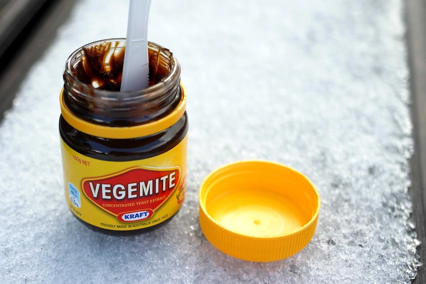 Open jar of Vegemite on ice.