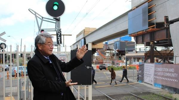 Labor MP Hong Lim inspecting a new elevated rail project in his Victorian electorate