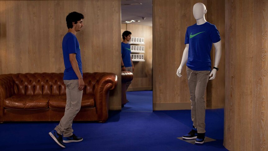Colour still image of actor Hamza Meziani dressed exactly the same as a store mannequin, in 20176 French film Nocturama.