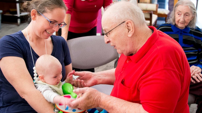 John Bruha interacts with baby Alexandra