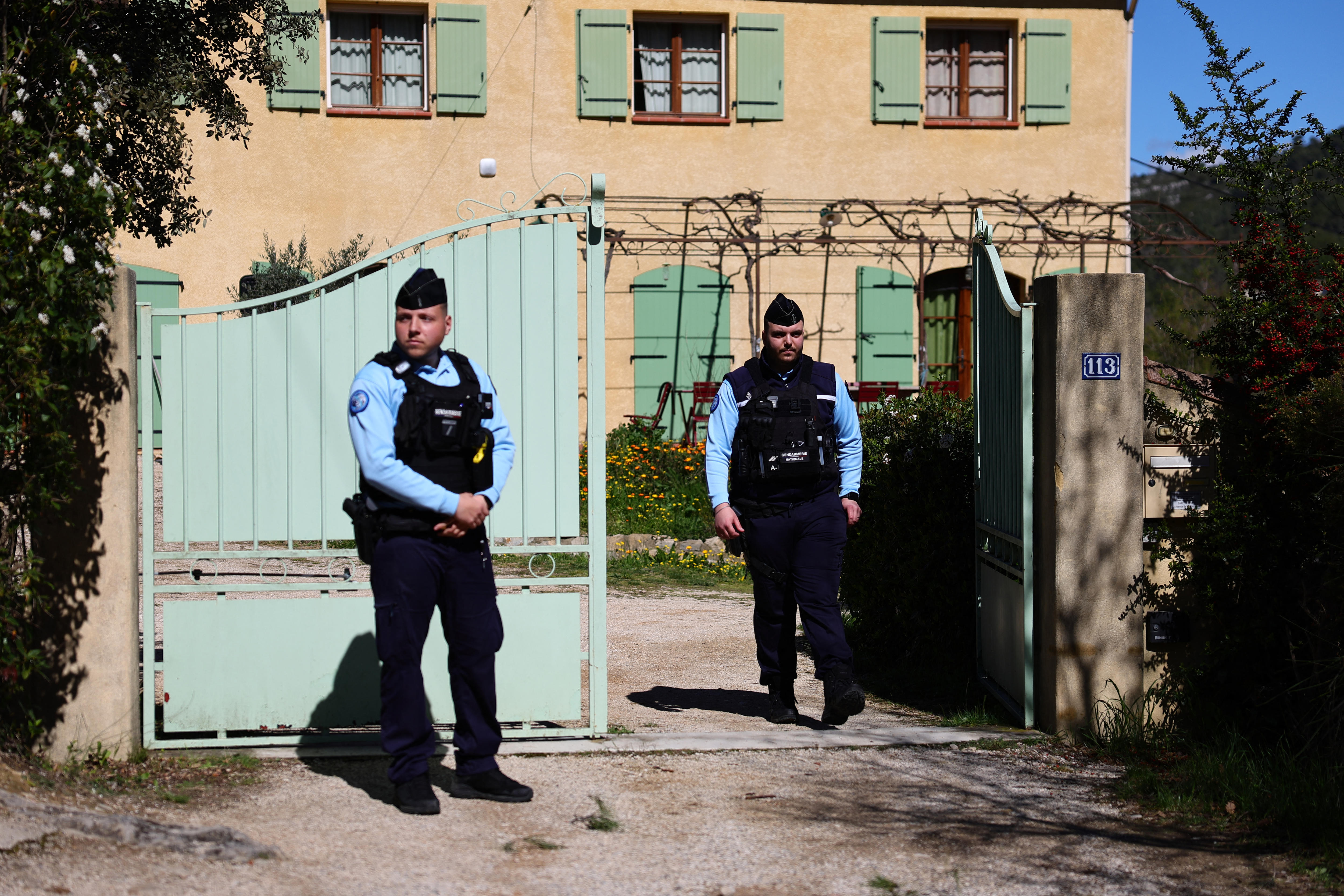 Police stand out the front of a home