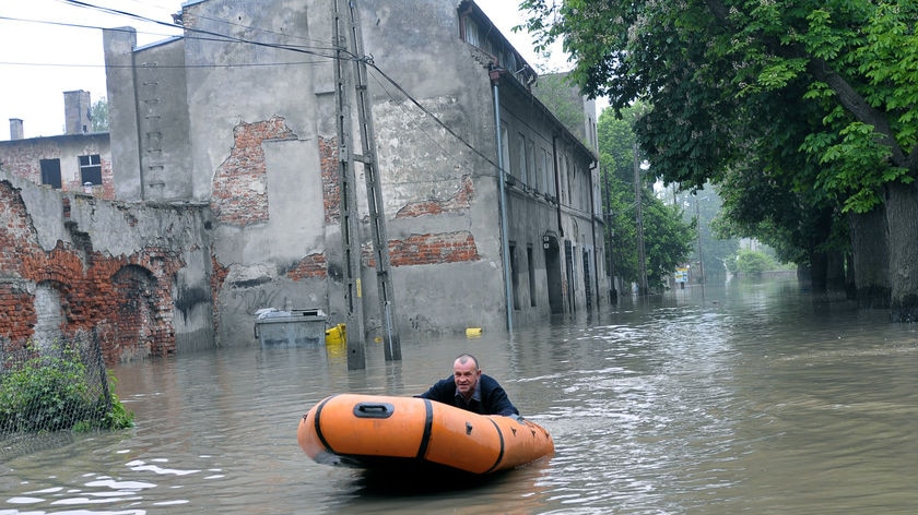 Worst ever: A man rides an inflatable boat through the city of Brzeg, near the Odra River