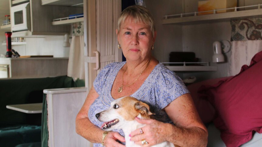 Waroona resident Marie Smith with her dog inside her caravan evacuated from bushfires in WA
