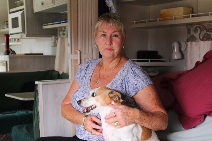 Waroona resident Marie Smith with her dog inside her caravan evacuated from bushfires in WA