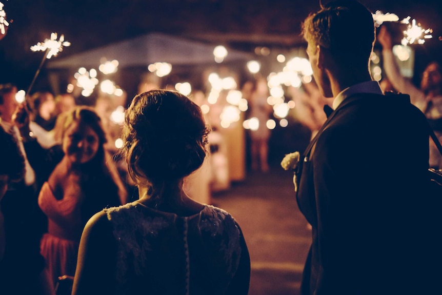 back of wedded couple at party