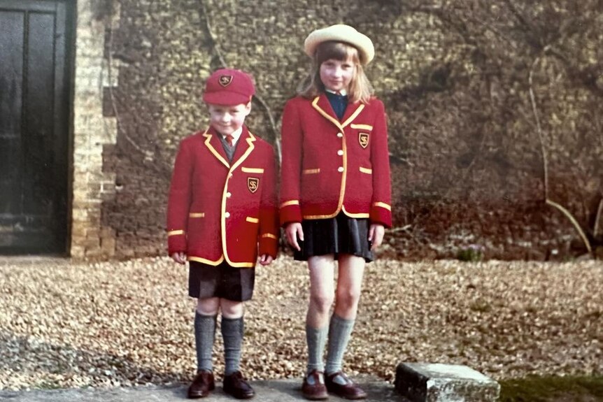 A little boy and girl in school uniforms