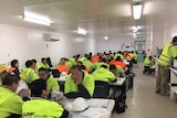 Chinese plasterers sit in a worker's room at the Royal Hobart Hospital.
