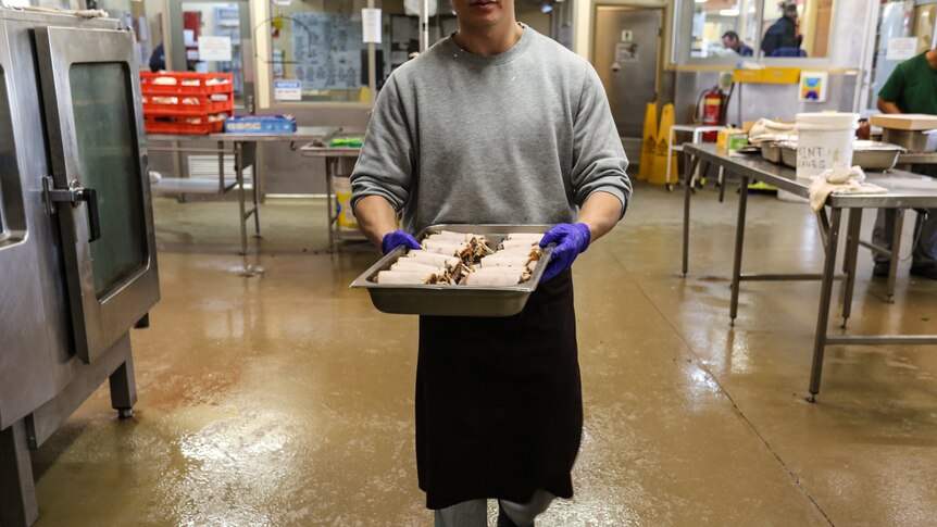 Nick carrying the donated meats he has tuned into a Christmas meal.