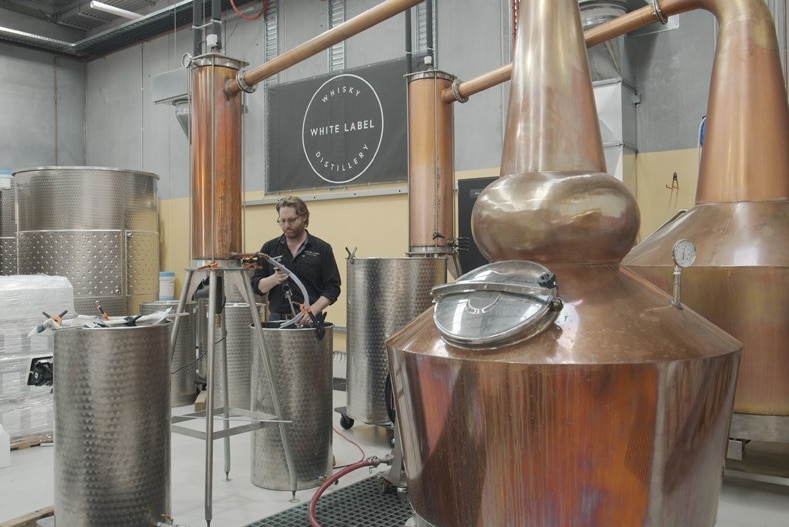 Brett Steel making hand sanitiser at White Label Distillery.