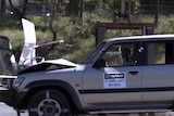 4WD crashes into road sign in crash tests to develop safer road signs.