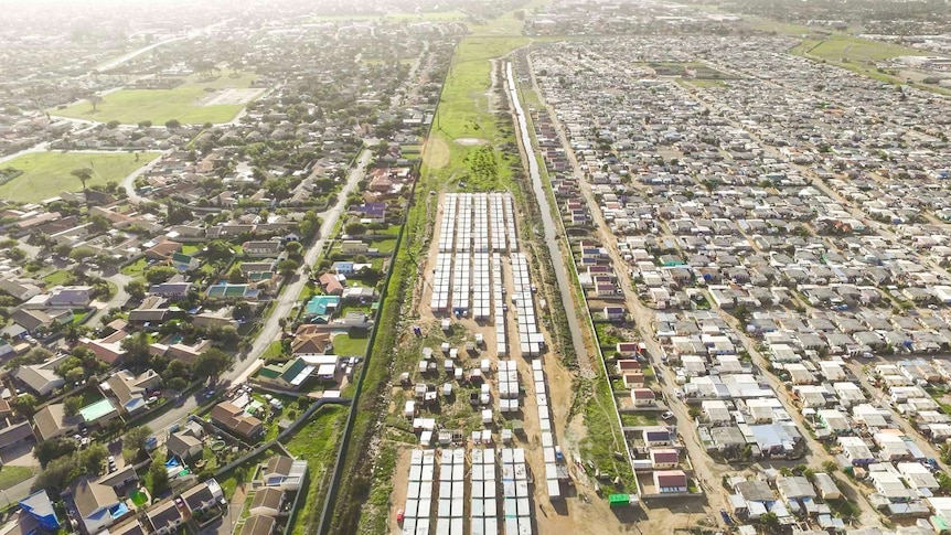 An aerial photo showing a rich neighbourhood and slums side by side