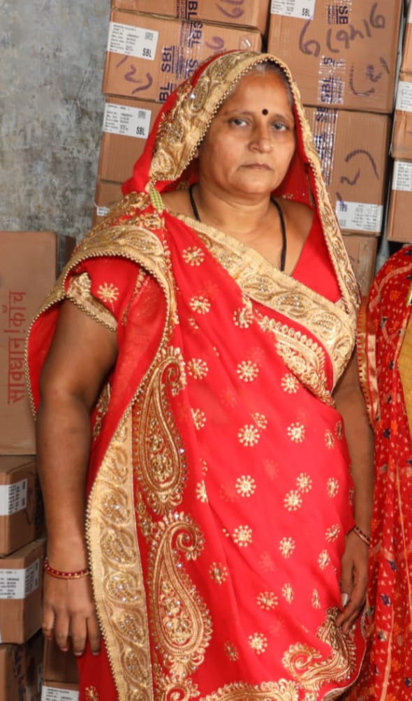 Indian woman in a red and gold dress. 