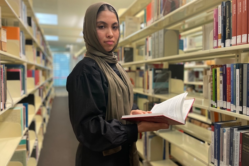 A woman holds a book