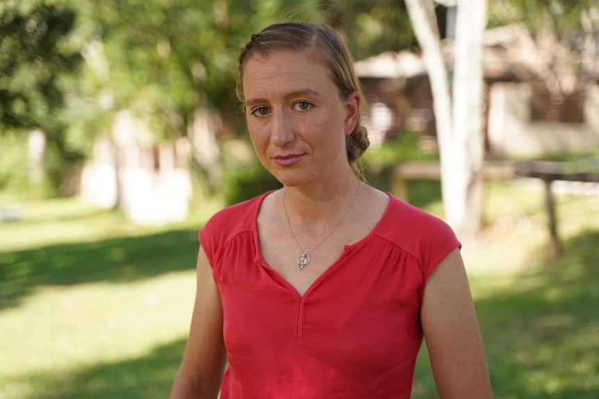 Virologist Associate Professor Kirsty Short with trees behind her