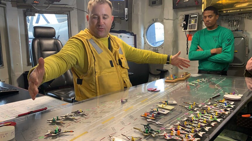 Flight deck leading petty officer Christopher Gibson stands over the ship's 'ouija board'