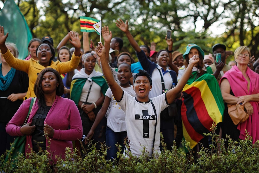 Zimbabweans sing and pray at a rally.