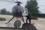 Helicopter makes dramatic rescue in flood