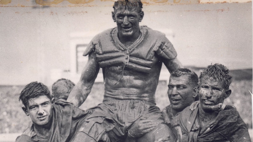 An archived image of St George rugby league players chairing off their captain after the 1963 grand final.