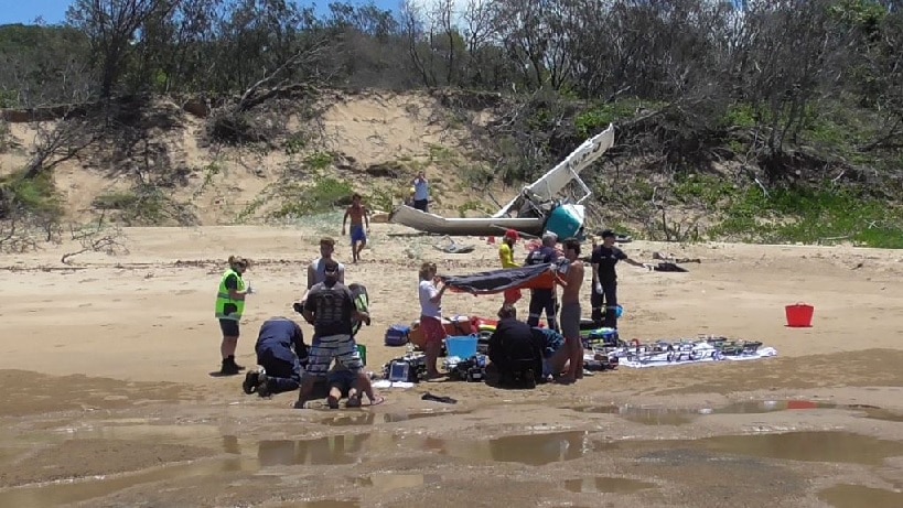 Paramedics work on two of the people injured in yesterday's crash.