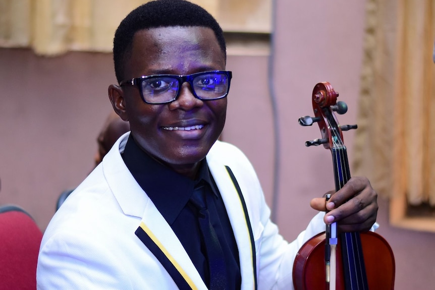 Nigerian doctor Chidozie Elvis Chidi-Ezeama holds a violin.