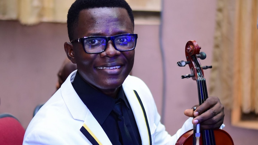 Nigerian doctor Chidozie Elvis Chidi-Ezeama holds a violin.