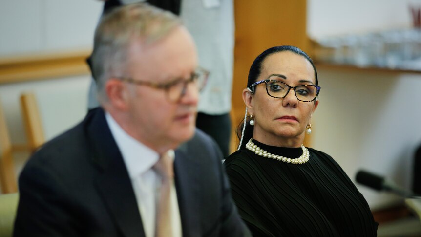 Linda Burney looks at Anthony Albanese as he speaks at a Voice referendum working group meeting
